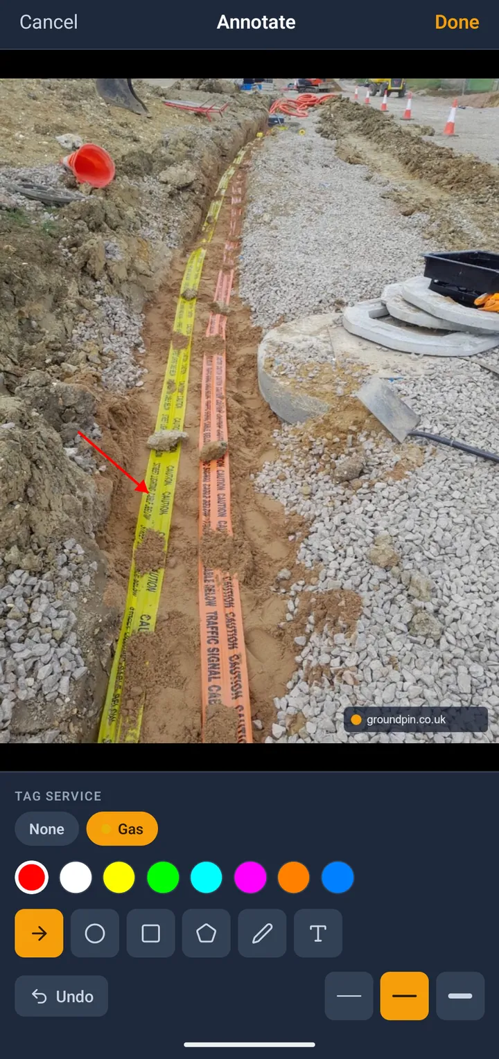 GroundPin photo annotation screen with arrow, shape and text tools over a trench photo